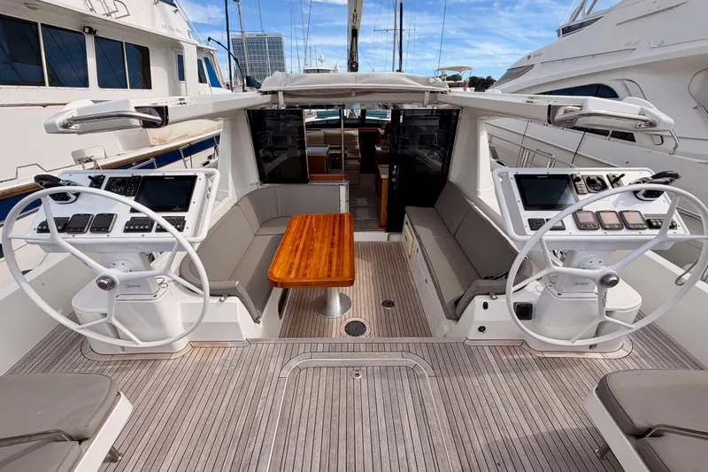 Slide: The Image of Luxurious 2016 Moody Decksaloon 54 yacht cockpit with dual steering wheels and elegant seating. - 41