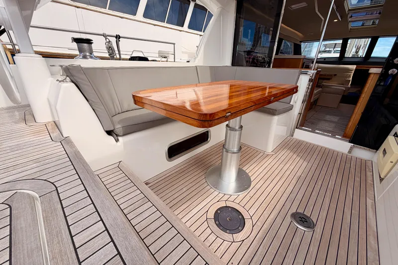 Slide: The Image of Luxurious 2016 Moody Decksaloon 54 yacht interior with elegant wooden table and seating area. - 46