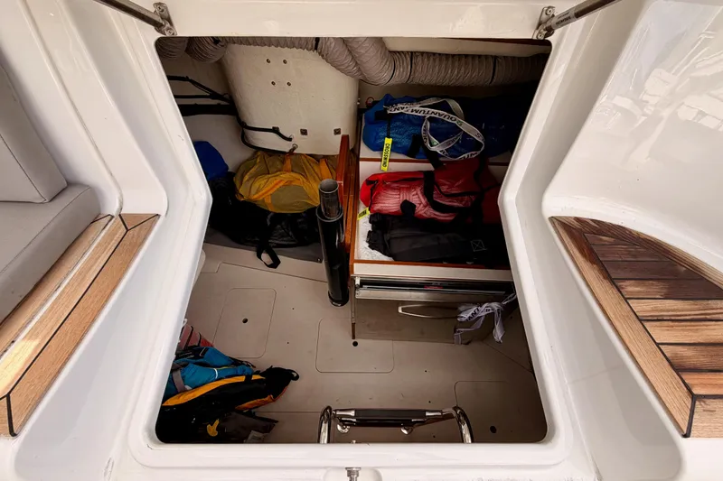 Slide: The Image of Storage compartment of 2016 Moody Decksaloon 54 yacht with various gear and equipment. - 48