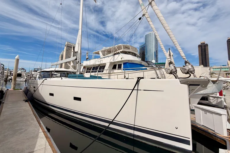 Slide: The Image of Luxury sailboat Moody Decksaloon 54, 2016 model, docked in a marina with city skyline. - 5