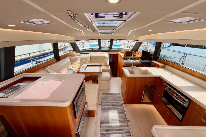 Slide: The Image of Luxurious interior of 2016 Moody Decksaloon 54 yacht with modern kitchen and seating area. - 52