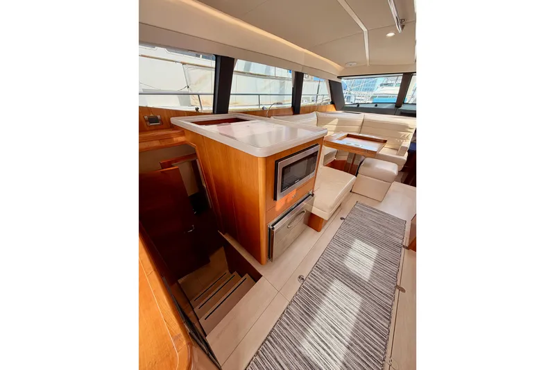 Slide: The Image of Luxurious interior of 2016 Moody Decksaloon 54 yacht with modern kitchen and seating area. - 53