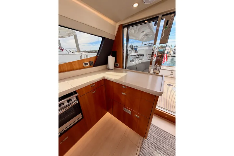 Slide: The Image of Interior of 2016 Moody Decksaloon 54 yacht with modern kitchen and marina view. - 58