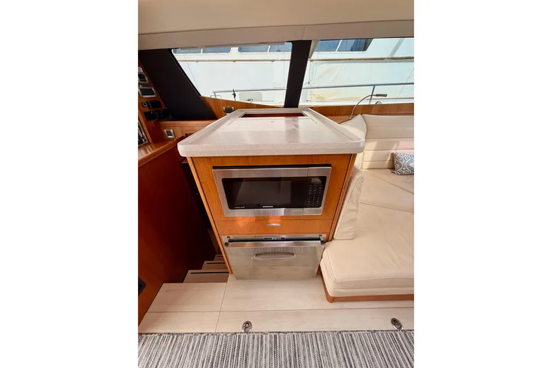 Slide: The Image of Modern kitchen area in a 2016 Moody Decksaloon 54 yacht with microwave and seating. - 62