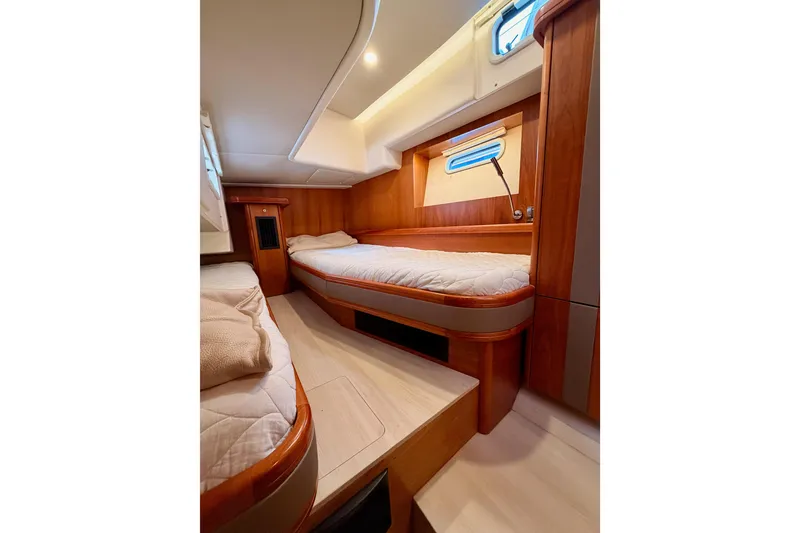 Slide: The Image of Luxurious cabin interior of 2016 Moody Decksaloon 54 yacht with wooden finishes and cozy beds. - 71