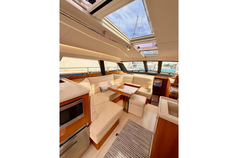 Slide: The Image of Luxurious interior of 2016 Moody Decksaloon 54 yacht with skylight and elegant seating area. - 75