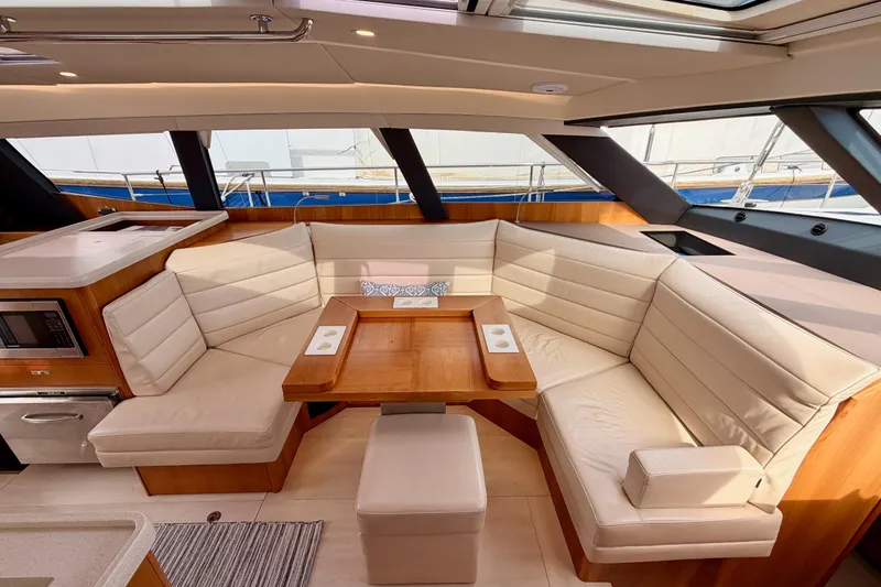 Slide: The Image of Luxurious interior of 2016 Moody Decksaloon 54 yacht with plush seating and wooden table. - 76