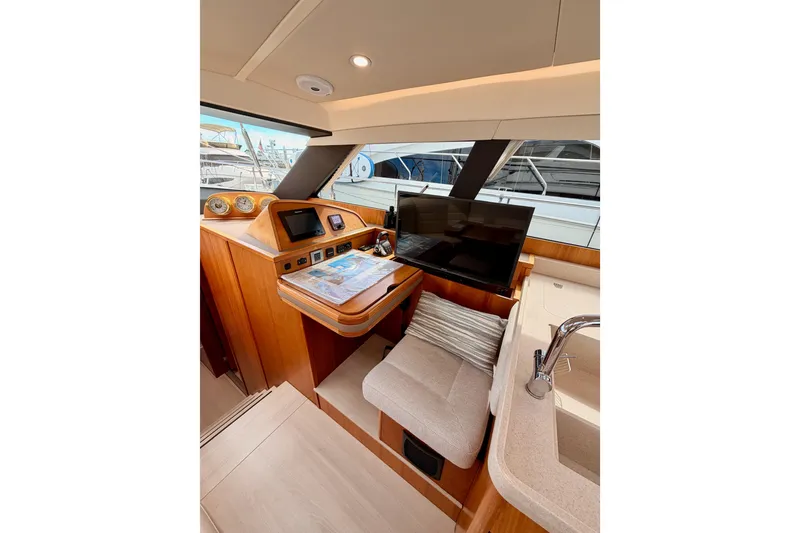Slide: The Image of Luxurious interior of 2016 Moody Decksaloon 54 yacht with navigation station and seating area. - 77