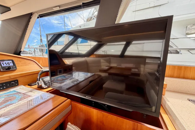 Slide: The Image of Interior of 2016 Moody Decksaloon 54 yacht with TV and navigation equipment. - 78