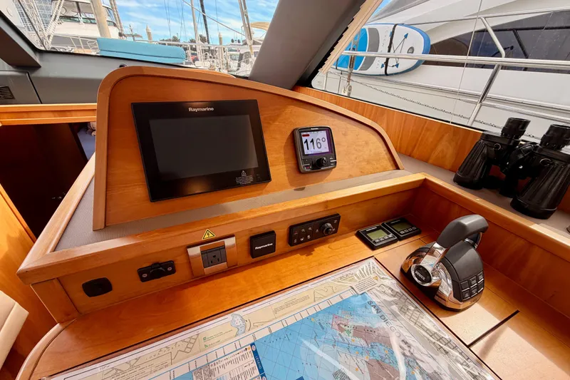Slide: The Image of Navigation station of 2016 Moody Decksaloon 54 yacht with Raymarine equipment and nautical chart. - 80