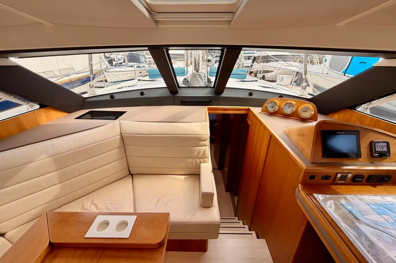Slide: The Image of Luxurious interior of 2016 Moody Decksaloon 54 yacht with elegant seating and navigation instruments. - 81