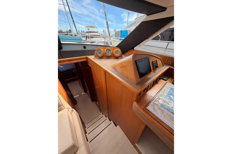 Slide: The Image of Interior of 2016 Moody Decksaloon 54 yacht with navigation instruments and wooden finish. - 82