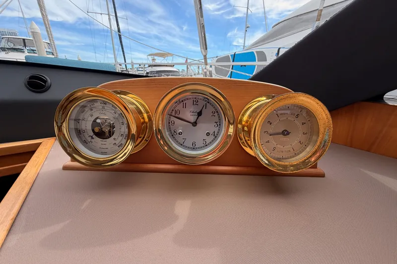 Slide: The Image of Golden nautical instruments on Moody Decksaloon 54 yacht, 2016 model, with marina view. - 83
