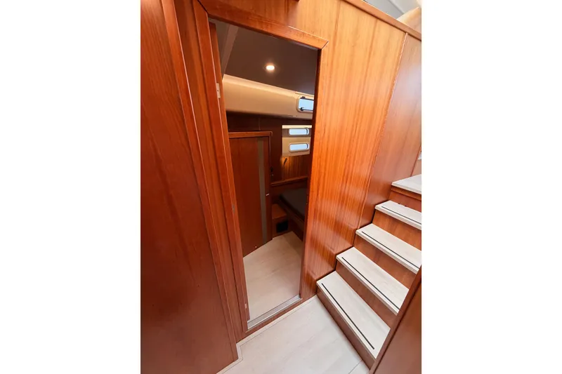 Slide: The Image of Interior of 2016 Moody Decksaloon 54 yacht with wooden paneling and stairs. - 86