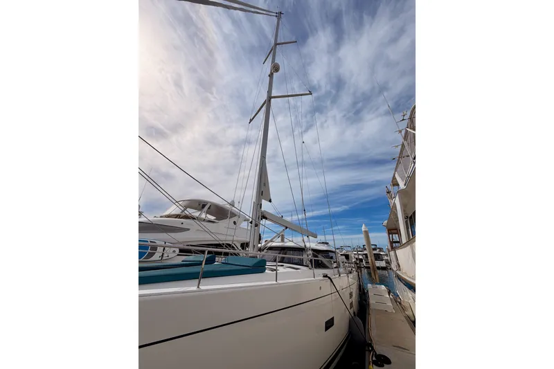 Slide: The Image of Sailboat Moody Decksaloon 54, 2016 model, docked under a partly cloudy sky. - 9
