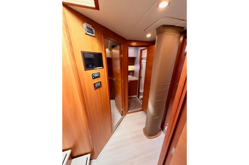 Slide: The Image of Interior of 2016 Moody Decksaloon 54 yacht, featuring wooden paneling and modern amenities. - 90