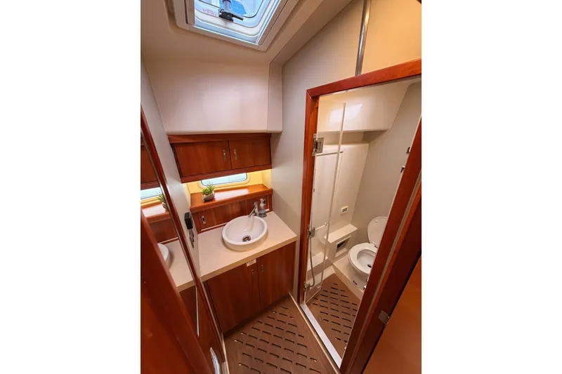 Slide: The Image of Luxurious bathroom in 2016 Moody Decksaloon 54 yacht with modern fixtures and wooden cabinetry. - 91