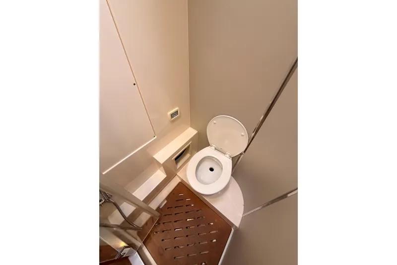 Slide: The Image of 2016 Moody Decksaloon 54 yacht bathroom with toilet and wooden floor. - 93