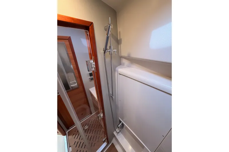 Slide: The Image of Shower area in 2016 Moody Decksaloon 54 yacht, featuring modern fixtures and wooden accents. - 94