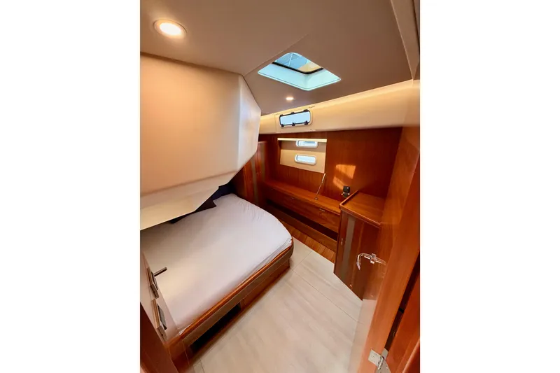Slide: The Image of Luxurious cabin interior of 2016 Moody Decksaloon 54 yacht with skylight and wooden finish. - 98