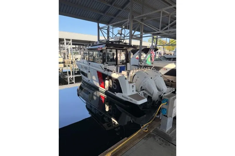 Slide: The Image of 2024 Jeanneau NC 895 Sport boat with dual 250 V6 engines at a marina. - 1