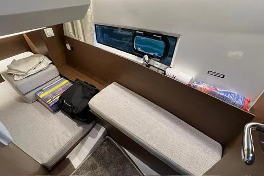 Slide: The Image of 2024 Jeanneau NC 895 Sport docked in a marina, surrounded by other boats. - 10