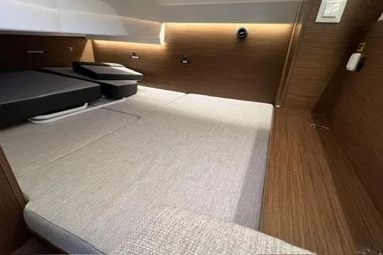 Slide: The Image of 2024 Jeanneau NC 895 Sport cabin interior with seating and window view. - 11