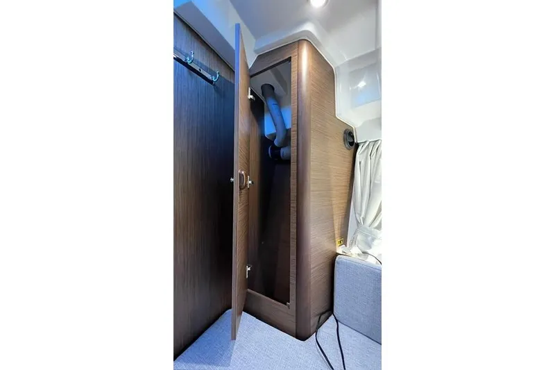 Slide: The Image of Interior view of 2024 Jeanneau NC 895 Sport cabin entrance with wooden doors. - 14