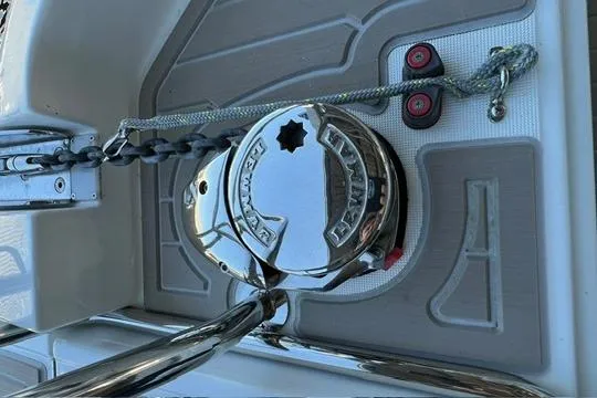 Slide: The Image of 2024 Jeanneau NC 895 Sport boat docked, showcasing sleek design and spacious deck area. - 21