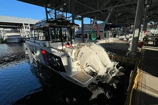 Slide: The Image of 2024 Jeanneau NC 895 Sport boat docked, featuring "Discovery" nameplate and Garmin equipment. - 24