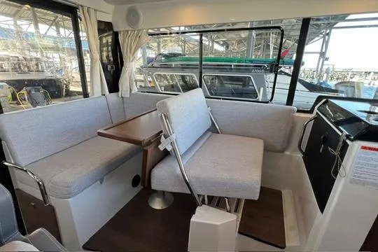 Slide: The Image of Interior of 2024 Jeanneau NC 895 Sport boat with seating and table. - 7