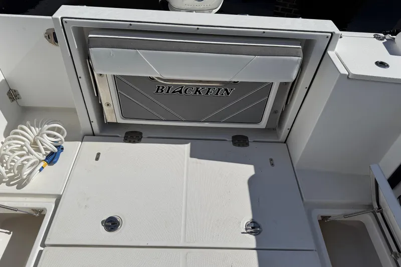Slide: The Image of 2019 Blackfin 242 CC boat deck with storage compartment and coiled rope. - 39
