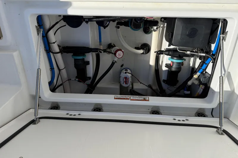Slide: The Image of 2019 Blackfin 242 CC boat compartment with visible wiring and components. - 42