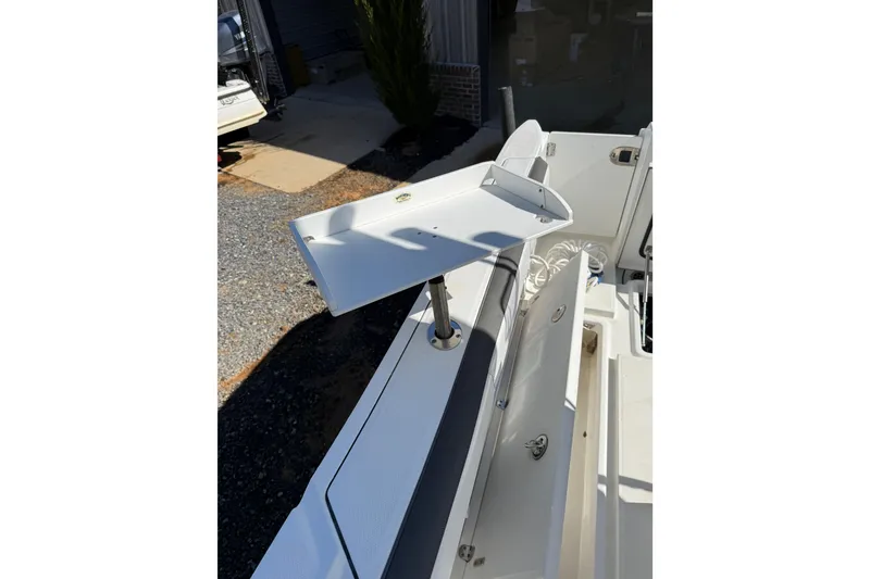 Slide: The Image of 2019 Blackfin 242 CC boat with open storage compartment and mounted accessory. - 47
