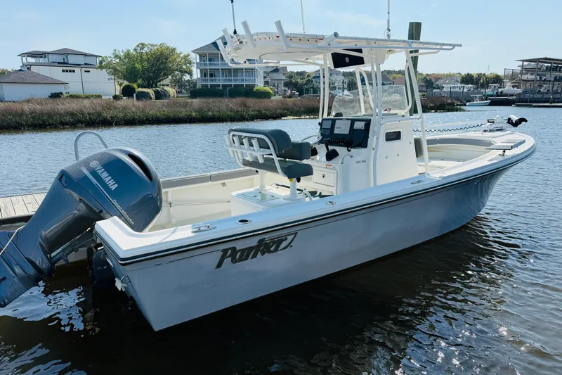 Slide: The Image of 2018 Parker 23SE Center Console boat docked on calm water. - 11