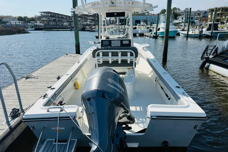 Slide: The Image of 2018 Parker 23SE Center Console boat docked with Yamaha outboard motor. - 12