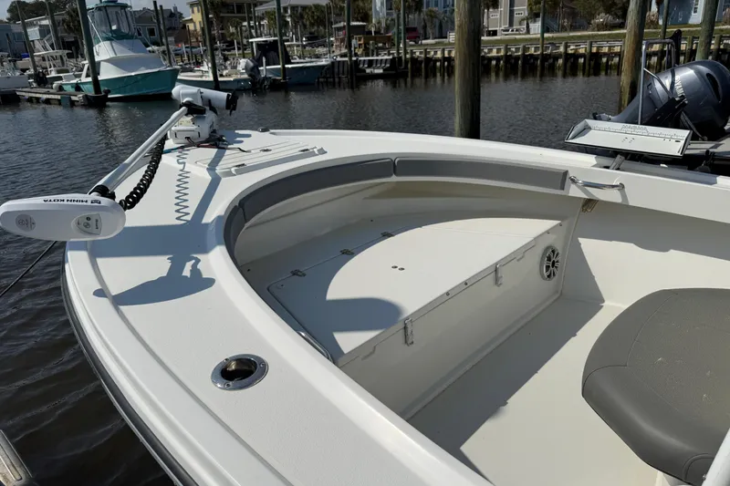 Slide: The Image of 2018 Parker 23SE Center Console boat docked, featuring spacious seating and modern equipment. - 14