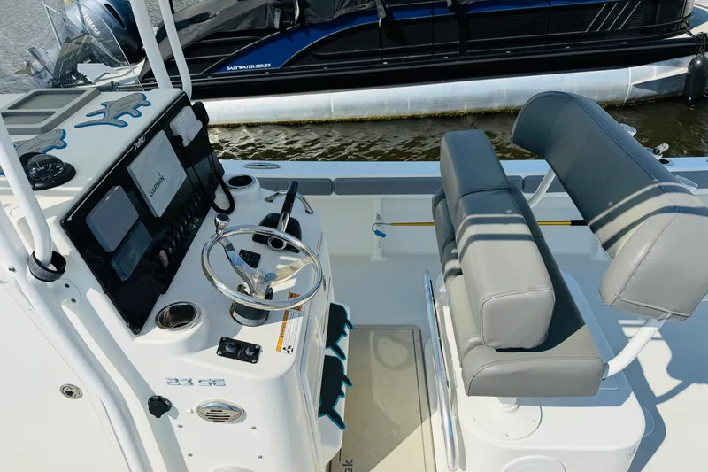 Slide: The Image of 2018 Parker 23SE Center Console boat interior with steering wheel and seating. - 16