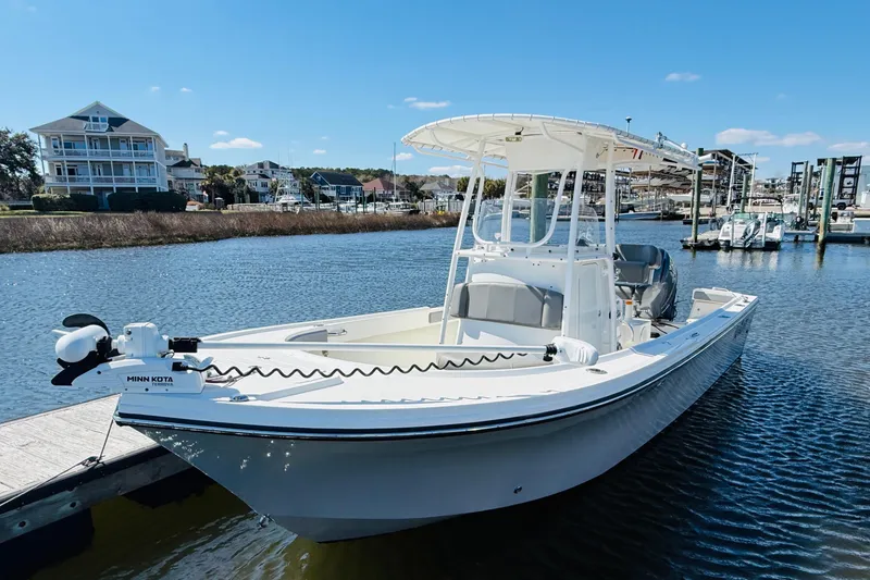 Slide: The Image of 2018 Parker 23SE Center Console boat docked in a scenic marina. - 2