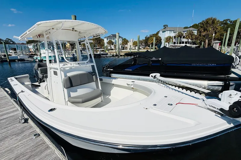 Slide: The Image of 2018 Parker 23SE Center Console boat docked at marina under clear blue sky. - 3