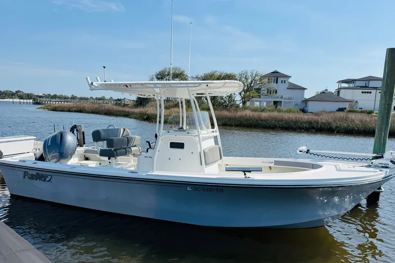 Slide: The Image of 2018 Parker 23SE Center Console boat docked by waterfront homes. - 9