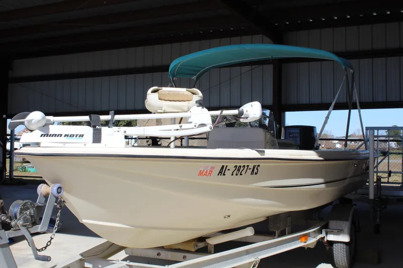 Slide: The Image of 1999 Scout 177 Sportfish boat on trailer with Minn Kota motor, under shelter. - 11