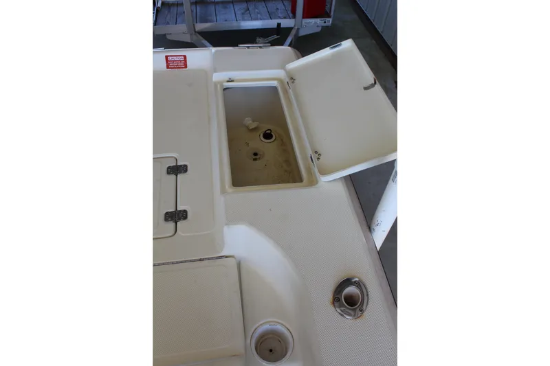 Slide: The Image of 1999 Scout 177 Sportfish boat deck with open storage compartment. - 12