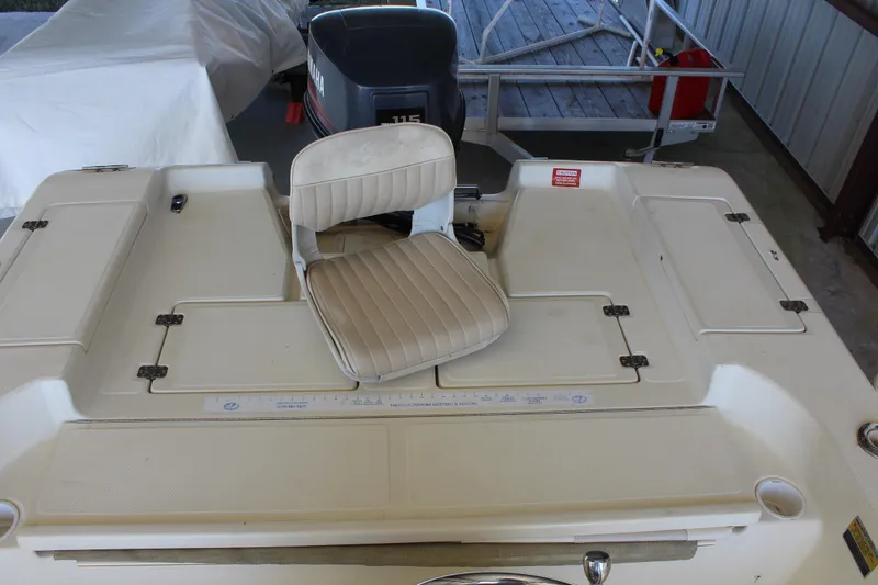 Slide: The Image of 1999 Scout 177 Sportfish boat with Yamaha 115 engine and cushioned seat. - 14