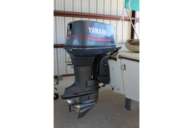 Slide: The Image of 1999 Scout 177 Sportfish with Yamaha 115 outboard motor in storage. - 6