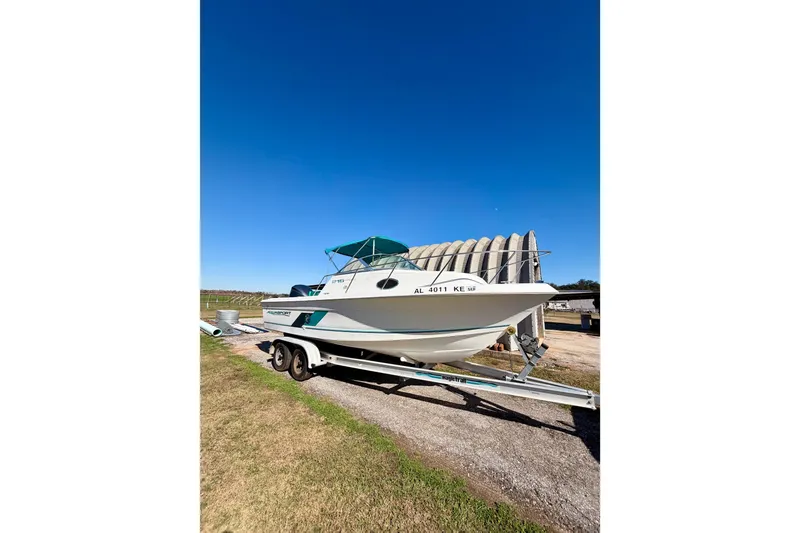 The Image of 2019 Aquasport 215 Explorer boat on trailer under clear blue sky. - 1
