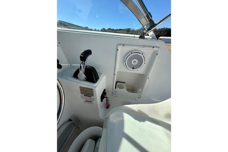 Slide: The Image of 2019 Aquasport 215 Explorer boat interior with control panel and speaker. - 11