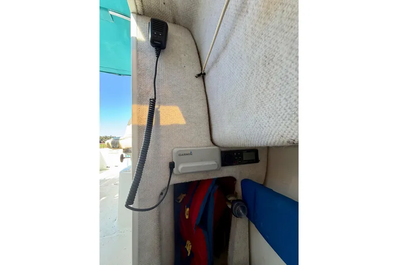 Slide: The Image of Interior of 2019 Aquasport 215 Explorer boat with Garmin device and radio equipment. - 13