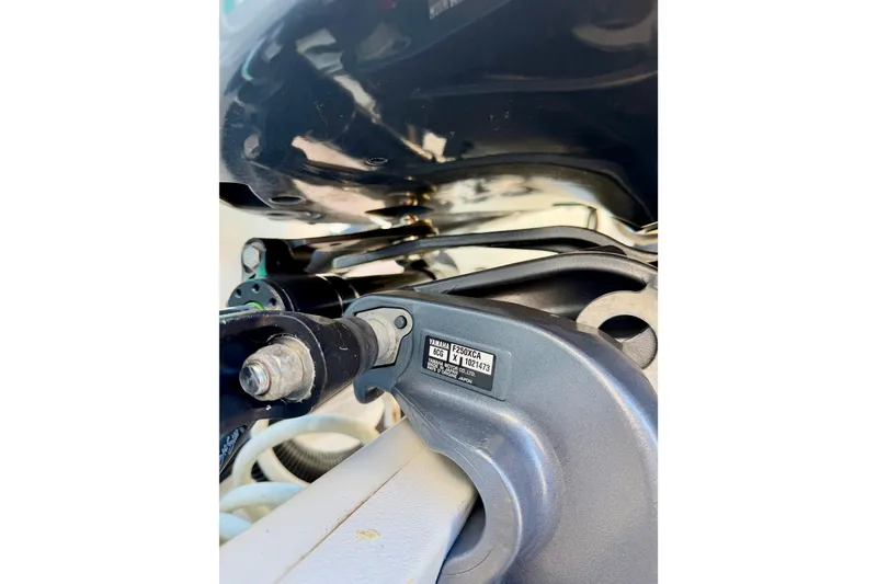 Slide: The Image of Close-up of 2019 Aquasport 215 Explorer boat engine components. - 16