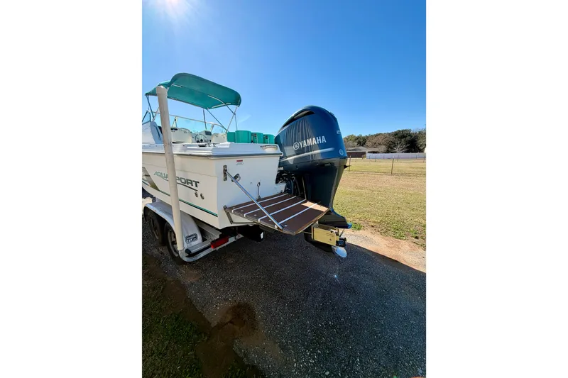 Slide: The Image of 2019 Aquasport 215 Explorer boat with Yamaha outboard motor on trailer. - 3